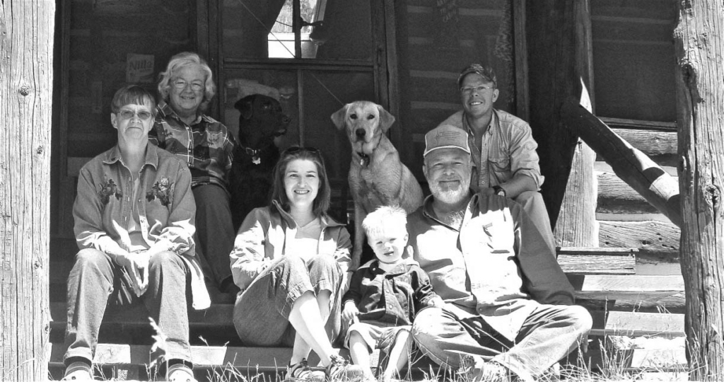 Family-sitting-on-Porch-with-dogs